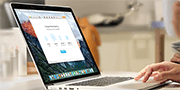 Woman using laptop on kitchen counter